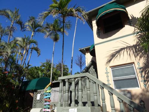 a house with palm trees in front of it at Suite Dreams Inn by the Beach in Key West