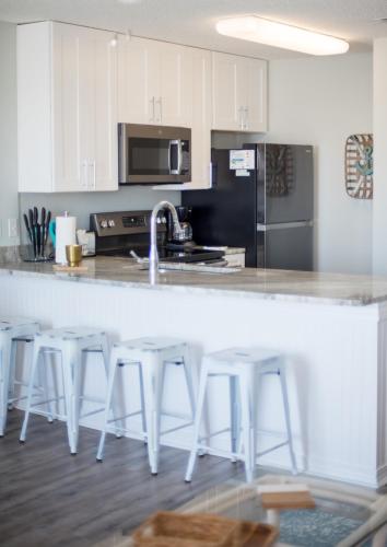 a kitchen with white cabinets and a white counter top at Grand Beach Resort Unit 313 in Gulf Shores