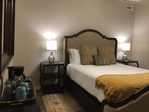 a bedroom with a bed and two lamps on tables at Barefoot Hills in Dahlonega