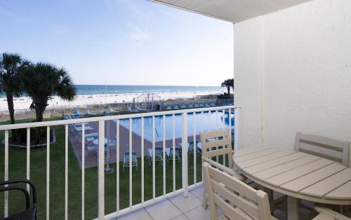 a balcony with a table and chairs and the beach at Sunswept 203 Condo in Orange Beach