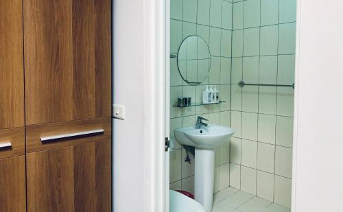 a bathroom with a sink and a mirror at Puli Islet Inn in Puli