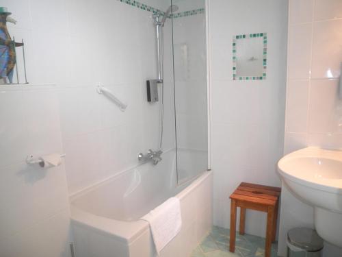 a bathroom with a shower and a toilet and a sink at Logis Auberge Du Centre in Chitenay