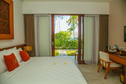 A bed or beds in a room at Rajavilla Lombok Resort - Seaside Serenity