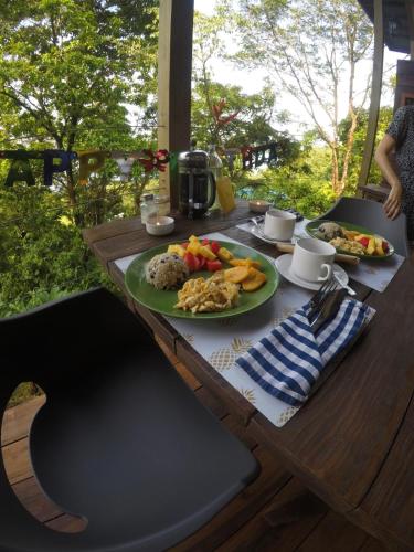 a wooden table with plates of food on it at Ataraxia in Bastimentos