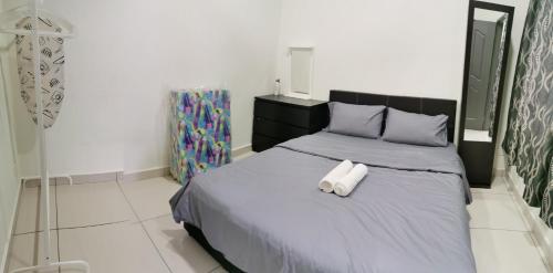 a bedroom with a bed with two towels on it at Taiping Centre Point Suite 7 by BWC in Taiping