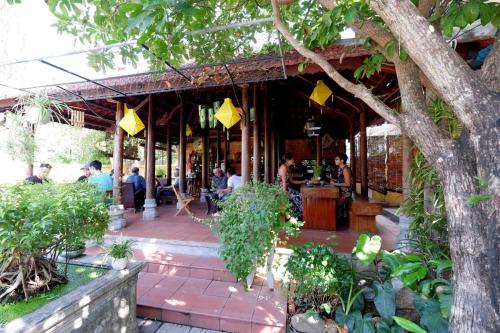 a restaurant with people sitting at a bar at Trầm Homestay in Thôn An Hòa