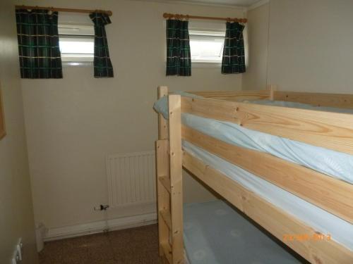 Letto a castello in camera con due finestre di The Mission Bunkhouse a Mallaig