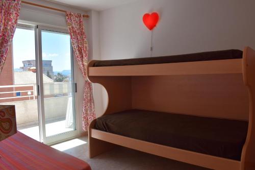 a bedroom with bunk beds and a red heart balloon at Sector 5 Napols AP844 in Oliva