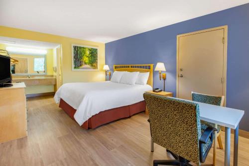 una camera d'albergo con un grande letto e una TV di Days Inn by Wyndham Grantville a Grantville