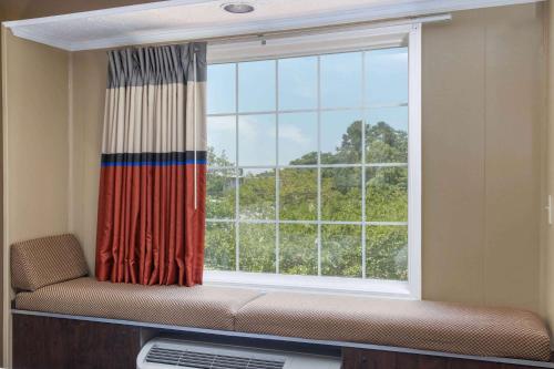 a window with a couch in front of a window at Microtel Inn & Suites by Wyndham Columbia Fort Jackson N in Columbia