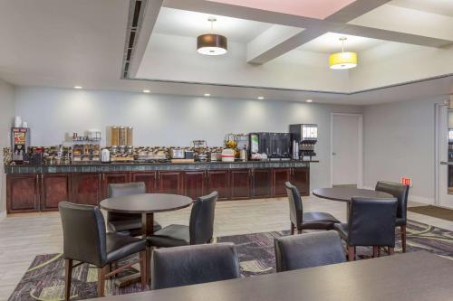 a restaurant with two tables and chairs and a counter at La Quinta by Wyndham Visalia/Sequoia Gateway in Visalia