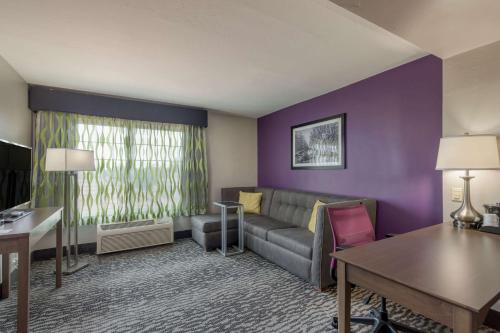 a living room with a couch and a table at La Quinta by Wyndham Visalia/Sequoia Gateway in Visalia