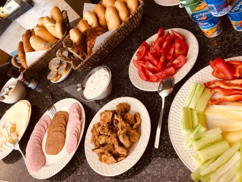 a table with plates of different types of food at Varga Villa in Orfű