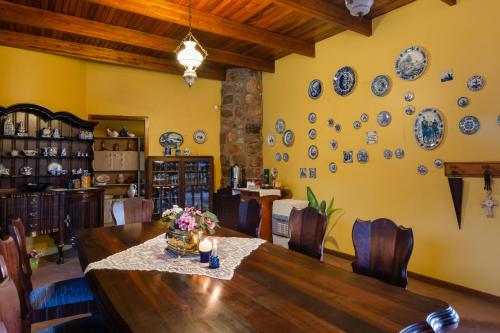 a dining room with a table and plates on the wall at Aberfeldy Bed & Breakfast in Midrand