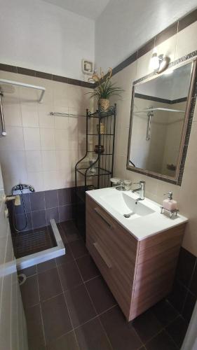 a bathroom with a sink and a mirror at TK-George Apartments by the Airport in Markopoulo