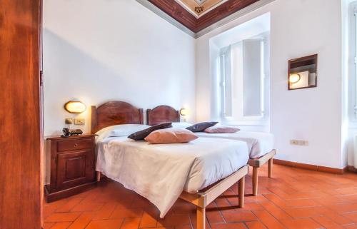 a bedroom with two beds with pillows on them at Hotel Costantini in Florence
