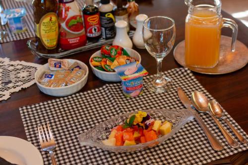 a table with a plate of food and a glass of orange juice at Aberfeldy Bed & Breakfast in Midrand