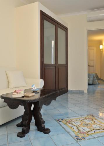 a living room with a table and a couch at Hotel Santa Lucia in Minori