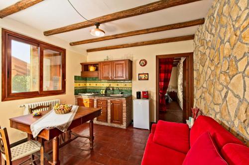 a kitchen with a table and a red couch at HORSE HOUSE in Ragalna