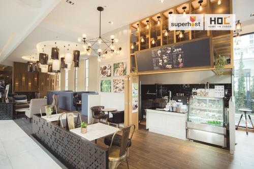 a restaurant with tables and chairs in a store at The Astra Condo by Ping in Chiang Mai