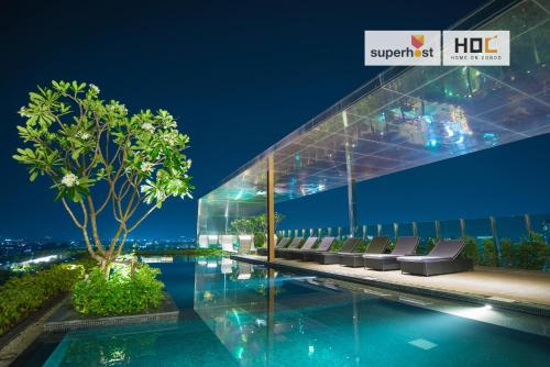 a building with a swimming pool at night at The Astra Condo by Ping in Chiang Mai