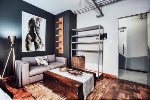 a living room with a couch and a coffee table at Cozy, Modern Living in Maboneng: Artison Lofts 105 in Johannesburg