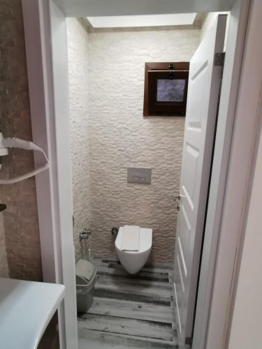 a small bathroom with a toilet and a sink at Club Pink Palace Hotel in Oludeniz