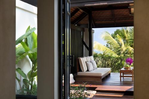 a living room filled with furniture and a patio at Anantara Lawana Koh Samui Resort -SHA Extra Plus in Chaweng