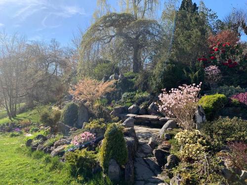 a garden with rocks and flowers on a hill at Moldegaard Farmhouse - Apartment B in Moldegard