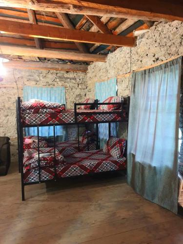 a room with three bunk beds in a room at Panorama guesthouse Mata C. in Adishi