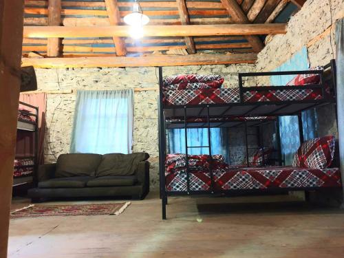 a room with two bunk beds and a couch at Panorama guesthouse Mata C. in Adishi