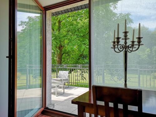 a dining room with a large glass window and a table at Willa Pory Roku in Łódź