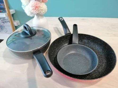 a skillet and a frying pan on a table at 2BR Jazz Suites Vivacity Megamall Kuching Sarawak in Kuching