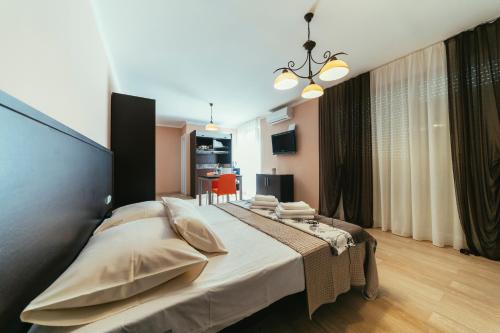 a bedroom with a large bed with pillows on it at Apartments Prestige Petrcane 1 in Petrcane