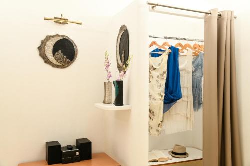 a room with a closet with clothes hanging at Iatis View Collection in Imerovigli