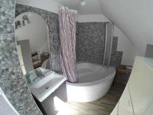 a bathroom with a sink and a toilet and a shower curtain at Ferien im FerienStudio1A in Brüggen