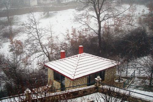 a house covered in snow with a roof at Nefeles in Neochori