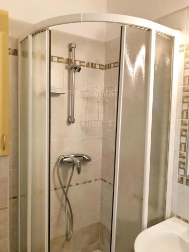 a shower with a glass door in a bathroom at Villa la Libertà! in Koper