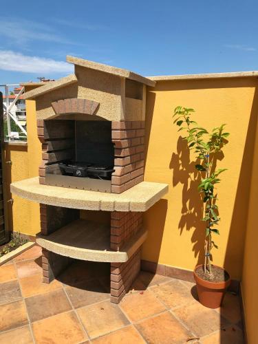 a stone outdoor fireplace with a tv on a patio at Villa la Libertà! in Koper