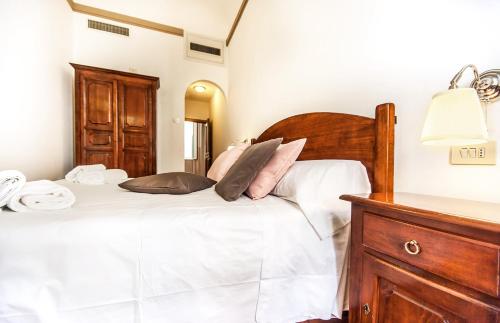 a bedroom with a bed with white sheets and pillows at Hotel Costantini in Florence
