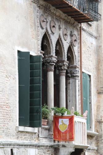 a building with a window with a flag on a balcony at Ca' Amadi in Venice