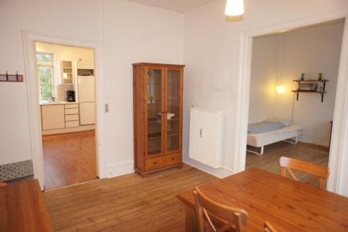 a living room with a wooden table and a dining room at id. 061. Jyllandsgade in Esbjerg