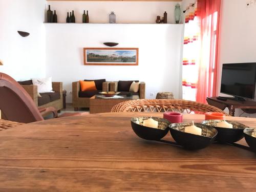 a table with bowls of food on top of it at Vila Velha Guest House in Mértola