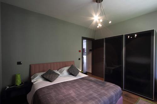 a bedroom with a large bed with a purple blanket at Il Ruscello Rooms and Luxury Suite in Roccaraso