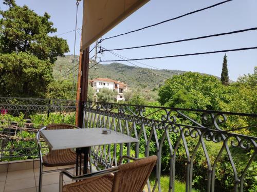 a table and chairs on a balcony with a view at Pagaseon Rooms and Apartments in Kala Nera