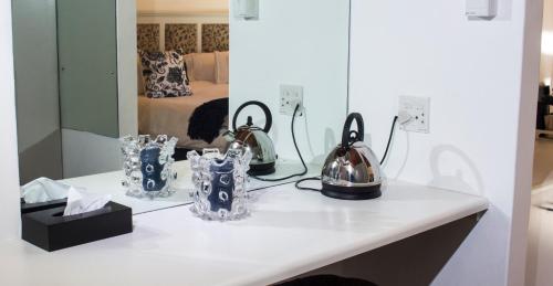 a table with two tea sets on top of it at Tsitsikhaya Lodge in Stormsrivier