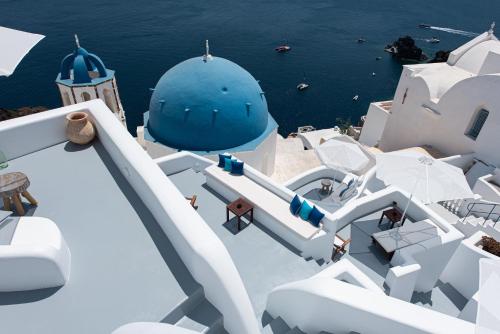 a slide on the side of a cruise ship with a blue dome at Oia Spirit Boutique Residences in Oia