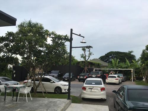 a street light with cars parked in a parking lot at Alinda Resort in Phetchaburi
