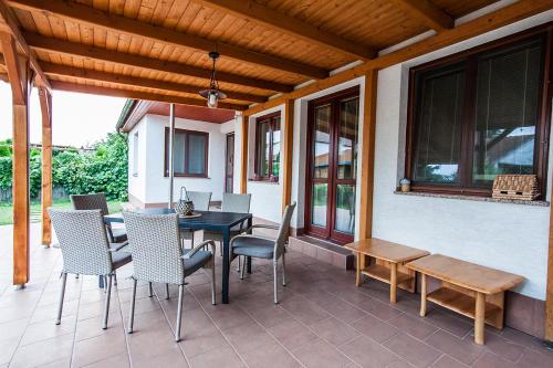 a patio with a table and chairs on a porch at Bílé domky in Lednice