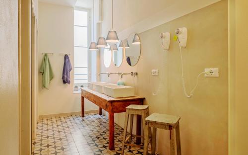 a bathroom with a sink and two stools at Costello in La Spezia